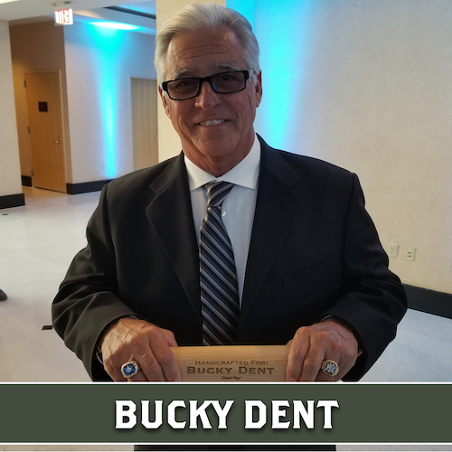 Bucky Dent holding a personalized wooden Dugout Mugs baseball bat mug horizontally.